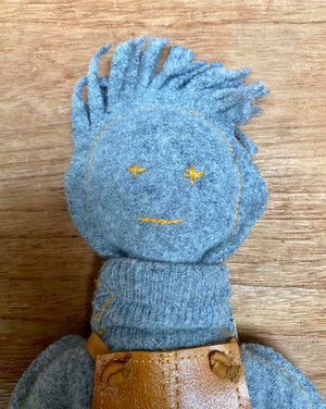 "The Disappointed One" character made of a grey pullover