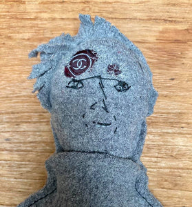 "The Disappointed One" character made of a grey pullover